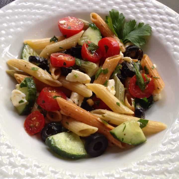Greek pasta salad in a white plate