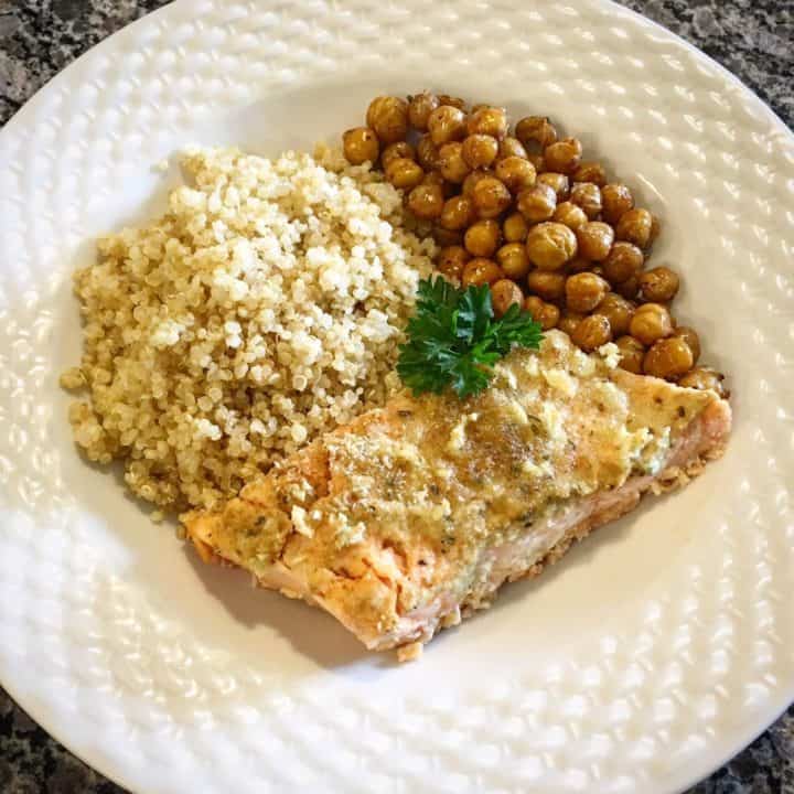 Garlic Dijon Salmon in a white bowl with quinoa and roasted chickpeas