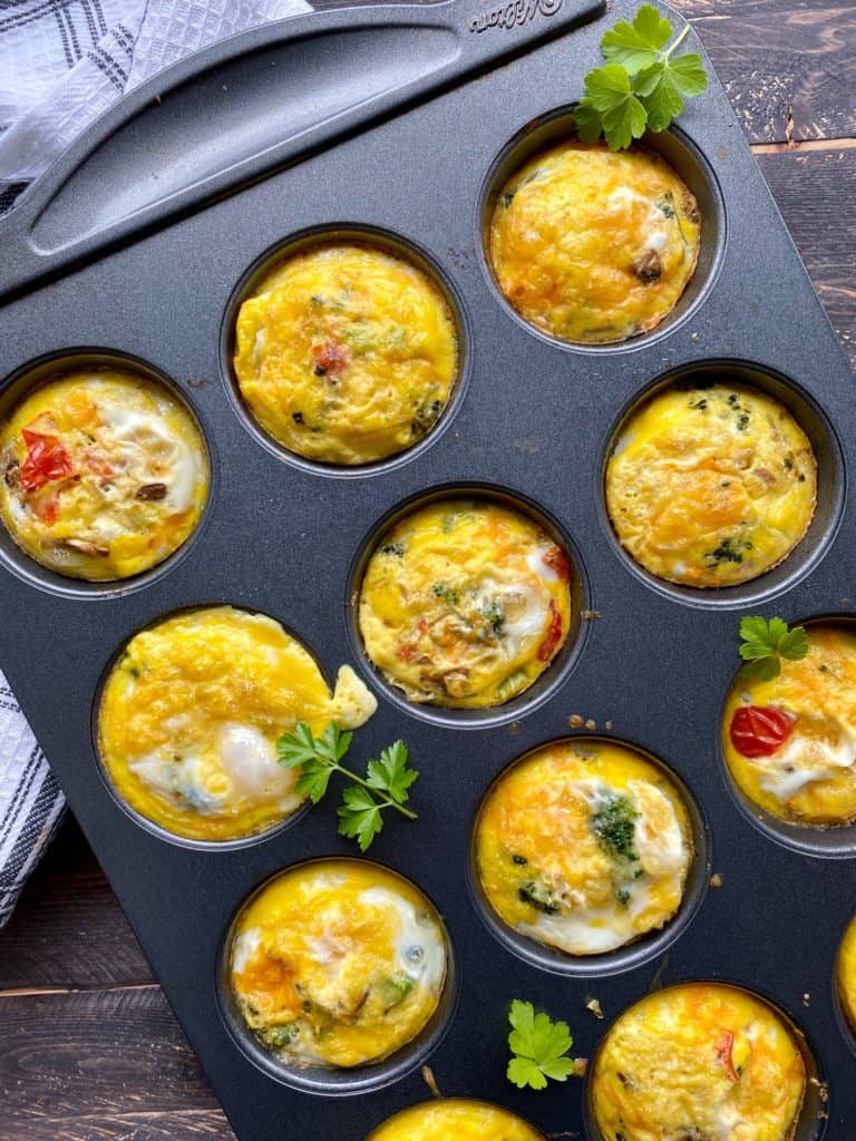 Egg muffins with vegetables and herbs in a muffin tin. gluten-free snacks