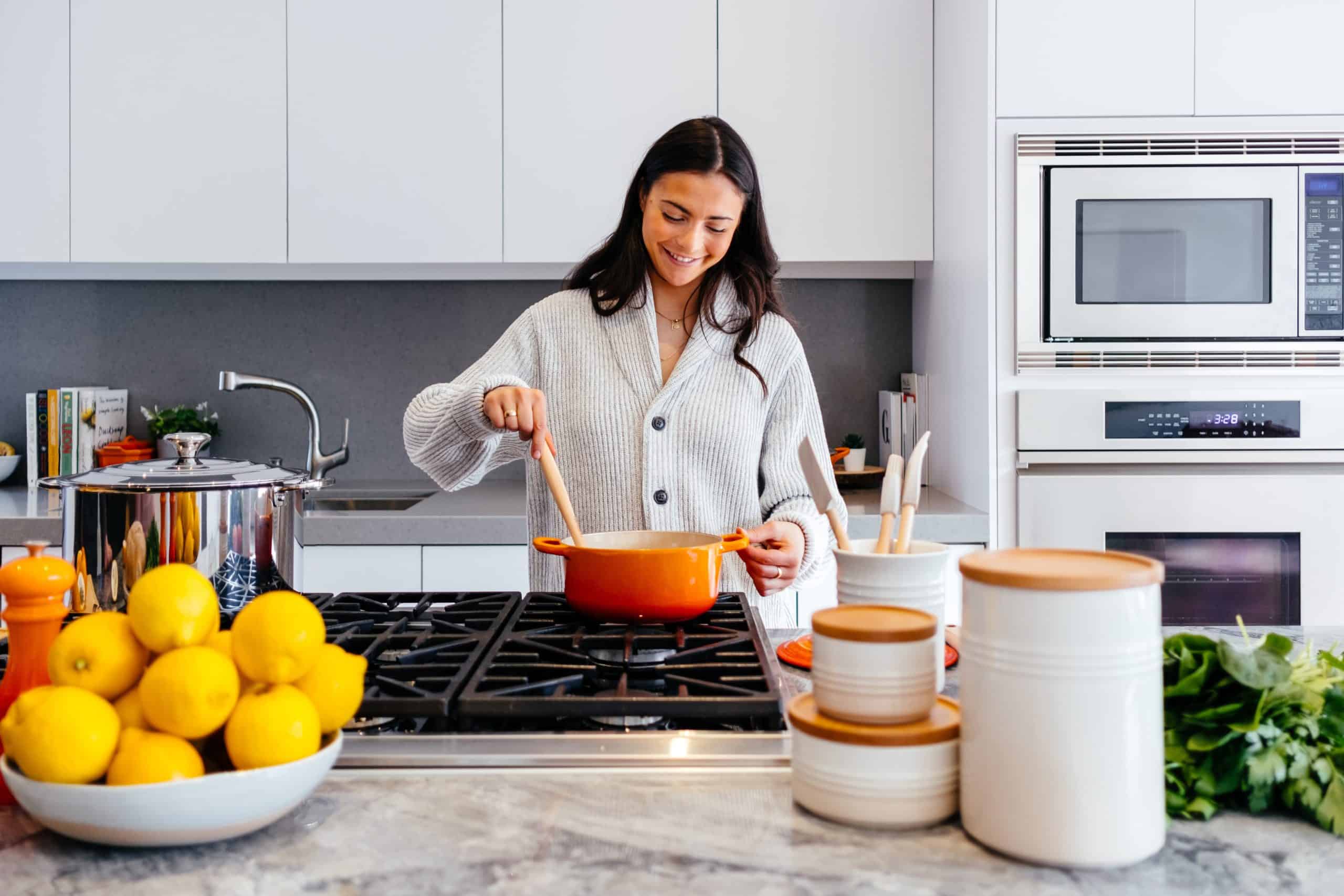 woman cooking kitchen; Top Fridge Pantry & Freezer Foods