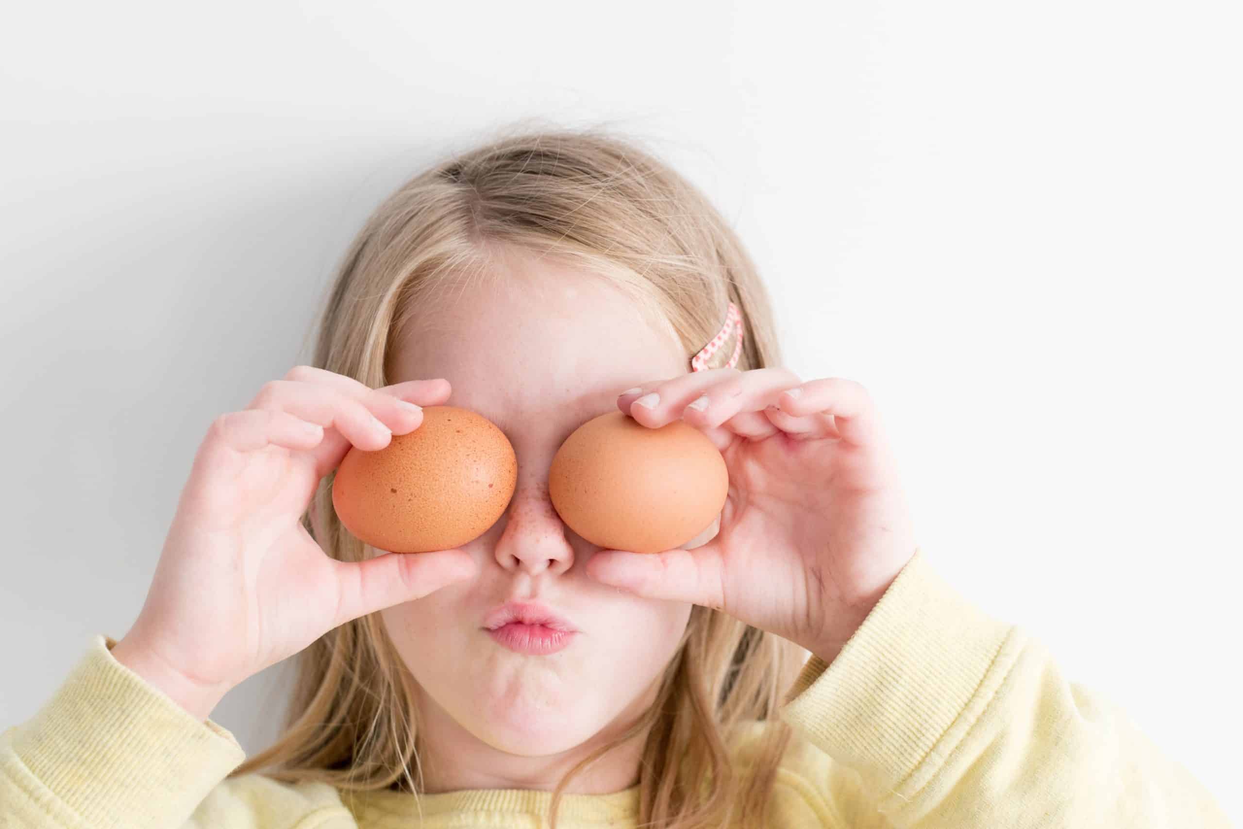 kid holding eggs