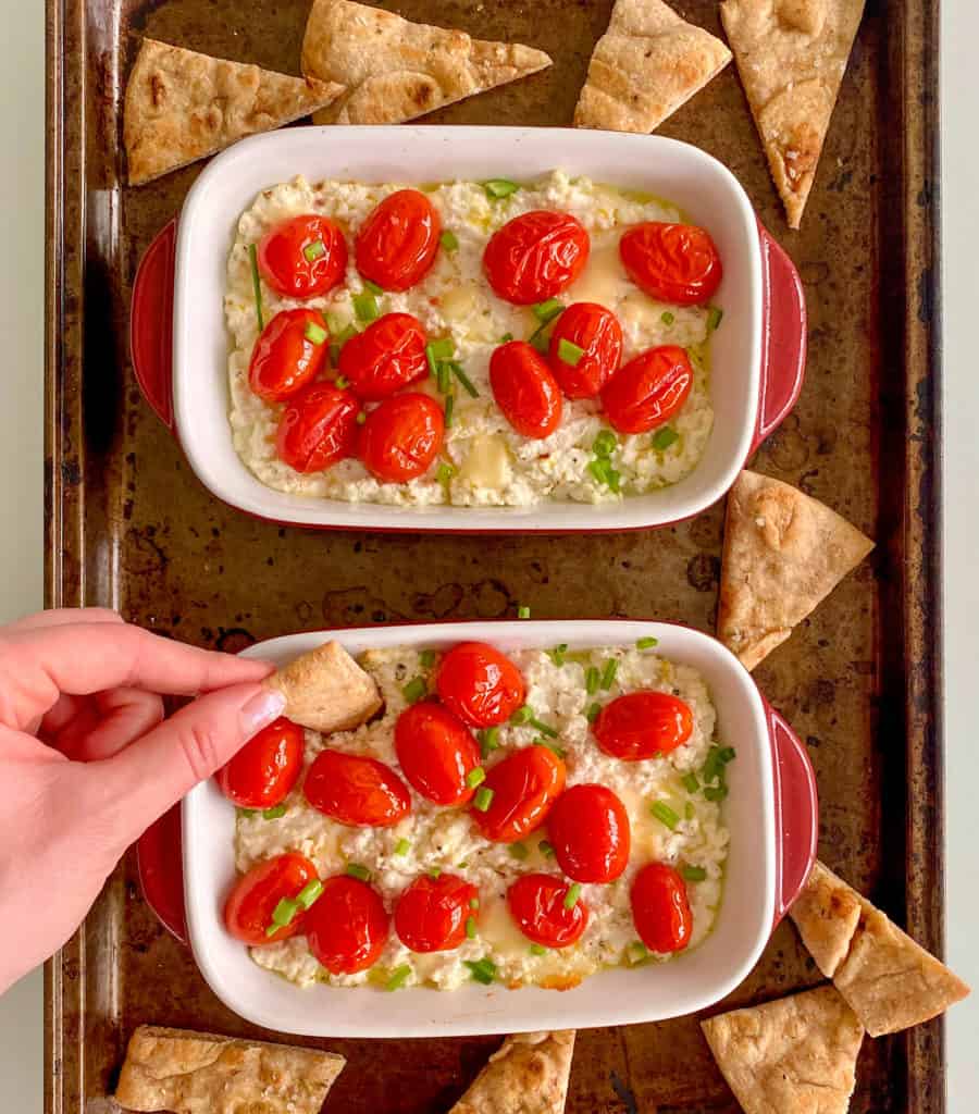 Garlic ricotta dip topped with roasted cherry tomatoes and green onions, served with pita chips.