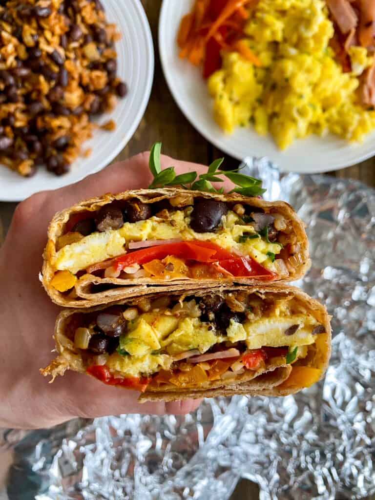holding healthy breakfast burrito