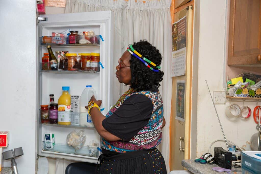 person looking in fridge, open fridge, fridge inventory to reduce food waste